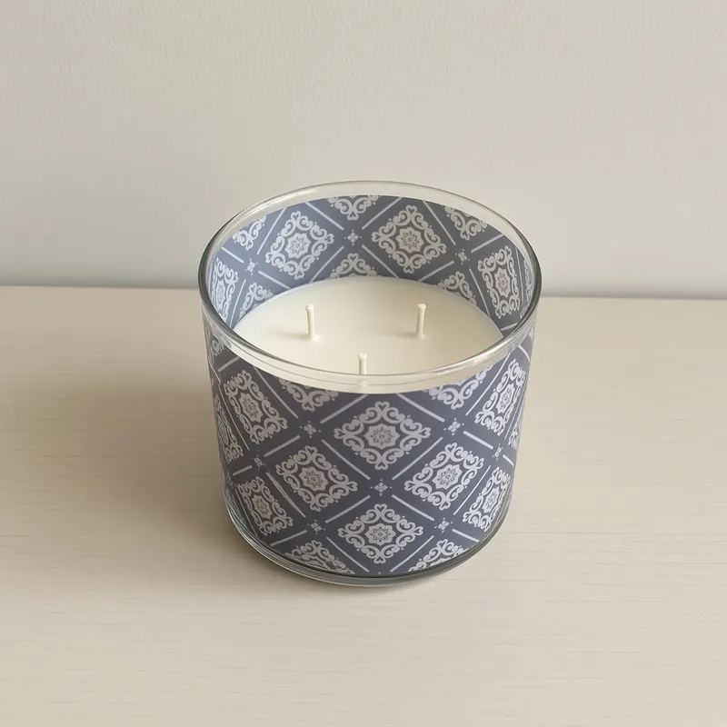 The candle on a plain table against a neutral wall
